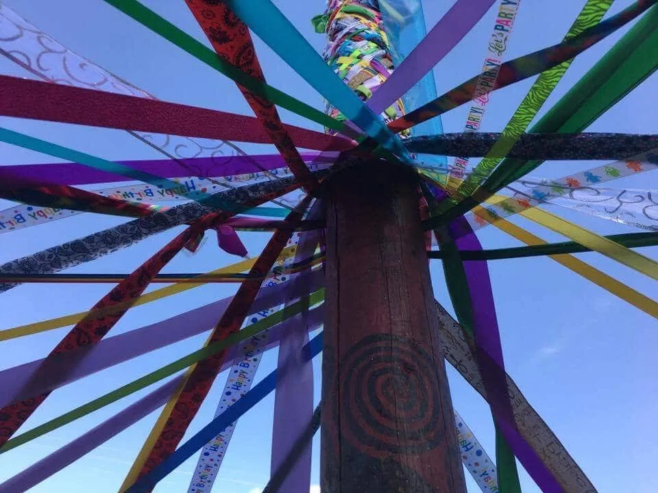 Colorful maypole ribbons viewed from below.