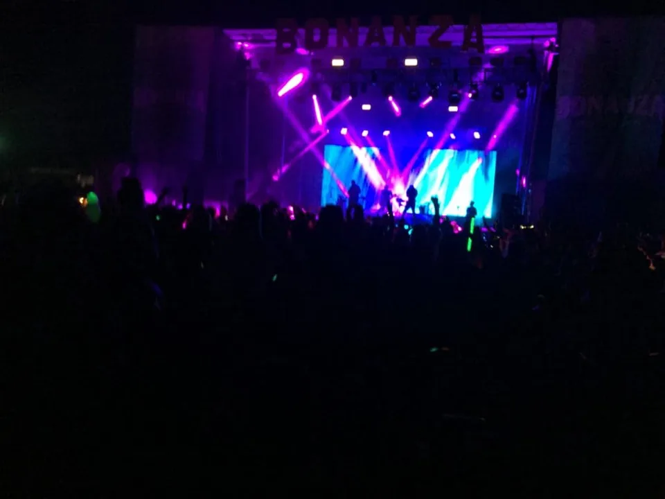 A concert stage illuminated by colorful lights.