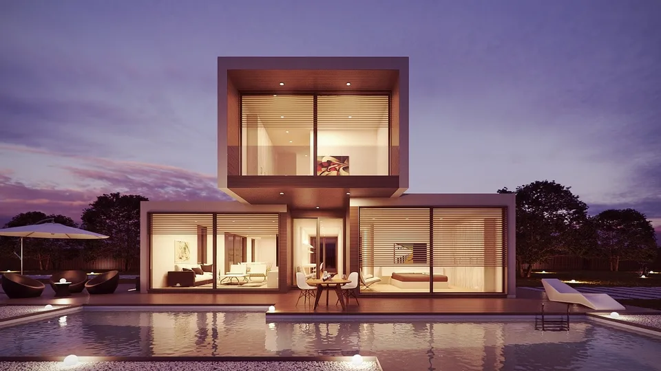 An illuminated modern home at dusk.