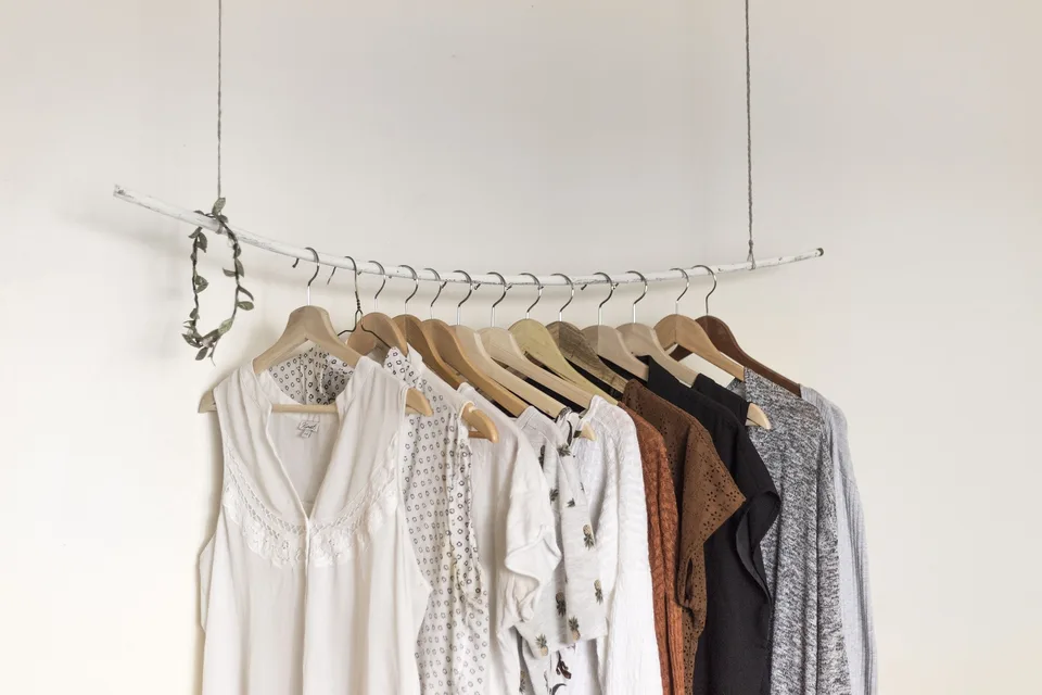 Clothes hanging from a rack.