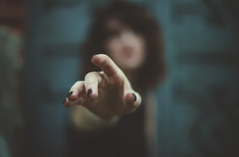 An outstretched hand pointing toward the camera.